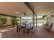 The expansive covered patio features a dining area and comfortable seating, perfect for enjoying outdoor meals and relaxation at 1153 W Mesquite St, Chandler, AZ 85224