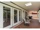 Charming covered patio features comfortable seating and double doors leading to indoor spaces, perfect for outdoor relaxation at 1153 W Mesquite St, Chandler, AZ 85224