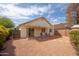 The backyard features a patio, gravel landscaping, and block wall providing privacy at 1200 W Boxelder Cir, Chandler, AZ 85224