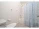Bathroom with toilet and bathtub shower combo with blue patterned shower curtain at 1200 W Boxelder Cir, Chandler, AZ 85224