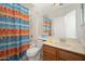 Bathroom with colorful curtain, toilet and sink with wood vanity at 1200 W Boxelder Cir, Chandler, AZ 85224