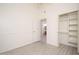 Bright bedroom with closet and view of bathroom with orange shower curtain at 1200 W Boxelder Cir, Chandler, AZ 85224