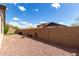 A beautiful, spacious backyard featuring desert landscaping and a brick wall, offering peace and quiet at 12057 W Ashby Dr, Peoria, AZ 85383