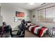 This bedroom features a bed, an American flag decor, and a comfortable gaming chair at 12057 W Ashby Dr, Peoria, AZ 85383