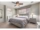 Comfortable bedroom with carpeted floor, ceiling fan, and a window offering plenty of natural light at 12057 W Ashby Dr, Peoria, AZ 85383