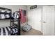 This bedroom features a bunk bed with striped linens, and a neutral carpet flooring at 12057 W Ashby Dr, Peoria, AZ 85383