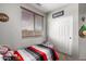 A bedroom with a comfortable bed and window with blinds that provide natural light at 12057 W Ashby Dr, Peoria, AZ 85383