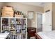 Cozy bedroom features a large shelving unit and bright natural light from the window at 12057 W Ashby Dr, Peoria, AZ 85383