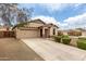 Charming single-Gathering home featuring a well-maintained front yard, desert landscaping, and a two-car garage at 12057 W Ashby Dr, Peoria, AZ 85383