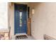 Inviting front entrance with a blue door, decorative welcome sign, and stucco siding at 12057 W Ashby Dr, Peoria, AZ 85383