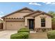 Charming single-story home features a two-car garage, well-kept landscaping, and a welcoming front porch at 12057 W Ashby Dr, Peoria, AZ 85383