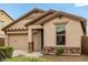 Charming single-Gathering home featuring a well-maintained front yard, desert landscaping, and a two-car garage at 12057 W Ashby Dr, Peoria, AZ 85383