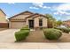 Charming single-Gathering home featuring a well-maintained front yard, desert landscaping, and a two-car garage at 12057 W Ashby Dr, Peoria, AZ 85383