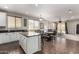 Open floor plan with kitchen island featuring barstool seating, a dining area, and living room at 12057 W Ashby Dr, Peoria, AZ 85383