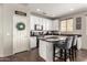Modern kitchen with granite countertops, stainless steel appliances, and a cozy breakfast bar at 12057 W Ashby Dr, Peoria, AZ 85383