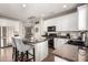 Well-lit kitchen featuring a center island with bar seating, granite counters, and stainless steel appliances at 12057 W Ashby Dr, Peoria, AZ 85383
