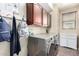 Laundry room with stainless steel washer and dryer, storage cabinets, and coat hooks at 12057 W Ashby Dr, Peoria, AZ 85383