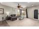 Comfortable living room featuring plush seating, a ceiling fan, and a sliding glass door at 12057 W Ashby Dr, Peoria, AZ 85383
