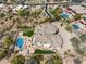 Aerial view of home showing unique rock pool and landscaped yard surrounded by desert landscape at 12639 N 136Th St, Scottsdale, AZ 85259