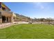 Lush backyard featuring a well-manicured lawn and desert landscaping with a pool and patio area at 12639 N 136Th St, Scottsdale, AZ 85259