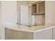 Granite-topped bar area features wooden cabinets and a sink for entertaining at 12639 N 136Th St, Scottsdale, AZ 85259