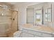 Bathroom featuring a single sink vanity, and a shower with glass enclosure and neutral-toned tile at 12639 N 136Th St, Scottsdale, AZ 85259