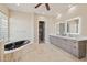 Bathroom showcasing a modern tub, double vanity, and walk-in closet at 12639 N 136Th St, Scottsdale, AZ 85259