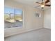 Bedroom featuring carpet floors, ceiling fan and a large window overlooking the outside at 12639 N 136Th St, Scottsdale, AZ 85259