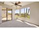 Bedroom featuring carpet floors, large windows with views of the patio, and a ceiling fan at 12639 N 136Th St, Scottsdale, AZ 85259