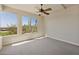 Bedroom featuring carpet floors, large windows with a scenic view, and a ceiling fan at 12639 N 136Th St, Scottsdale, AZ 85259