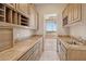 Butler's pantry with custom cabinetry, granite countertop, a sink, and a pass-through to the dining room at 12639 N 136Th St, Scottsdale, AZ 85259