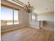 Bright dining room featuring hardwood floors, modern chandelier, and large windows with expansive views at 12639 N 136Th St, Scottsdale, AZ 85259