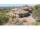 Desert home showcasing 3-car garage, tile roof, and desert landscape against a mountain backdrop at 12639 N 136Th St, Scottsdale, AZ 85259
