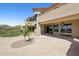 Exterior showcases a large stone patio with desert landscaping, covered porch, and outdoor ceiling fans at 12639 N 136Th St, Scottsdale, AZ 85259
