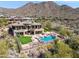 This beautiful home boasts a sparkling pool, lush landscaping and stunning mountain views at 12639 N 136Th St, Scottsdale, AZ 85259