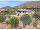 Custom home features lush green grass, swimming pool with waterfall feature, and desert landscape at 12639 N 136Th St, Scottsdale, AZ 85259