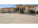 A spacious three-car garage is complimented by beautiful desert landscaping at 12639 N 136Th St, Scottsdale, AZ 85259