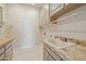 Spacious laundry room with tile floors, a utility sink, and cabinetry at 12639 N 136Th St, Scottsdale, AZ 85259