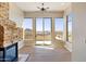 Living room featuring a fireplace and a wall of windows with scenic views and a fan at 12639 N 136Th St, Scottsdale, AZ 85259
