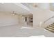 Spacious living room with staircase, tile floors, and neutral walls, creating a bright and welcoming atmosphere at 12639 N 136Th St, Scottsdale, AZ 85259