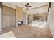 Expansive living room with stone fireplace, custom built-ins, hardwood floors and view into the kitchen at 12639 N 136Th St, Scottsdale, AZ 85259