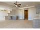 Open concept living room featuring tile flooring, a breakfast bar, and a built in bookcase at 12639 N 136Th St, Scottsdale, AZ 85259