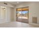 Inviting indoor area with a patio view showcasing the backyard oasis with its rock features and outdoor kitchen at 12639 N 136Th St, Scottsdale, AZ 85259