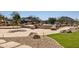 Expansive pool area with rock details is surrounded by desert landscaping and a small tree at 12639 N 136Th St, Scottsdale, AZ 85259