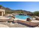 Inviting pool with rock waterfall feature offers a luxurious backyard oasis with mountain views at 12639 N 136Th St, Scottsdale, AZ 85259