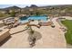 An in-ground pool and spa featuring a rock waterfall design with a stone paver patio at 12639 N 136Th St, Scottsdale, AZ 85259