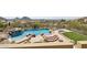 An in-ground pool and spa featuring a rock waterfall design with a stone paver patio at 12639 N 136Th St, Scottsdale, AZ 85259