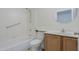 A bathroom with white tile and fixtures with a wood-look vanity at 1297 E Avenida Kino --, Casa Grande, AZ 85122