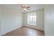 A bedroom with a wood-look floor, a window with natural light and a ceiling fan at 1297 E Avenida Kino --, Casa Grande, AZ 85122
