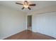 A bedroom with a wood-look floor, a ceiling fan and a closet with folding doors at 1297 E Avenida Kino --, Casa Grande, AZ 85122